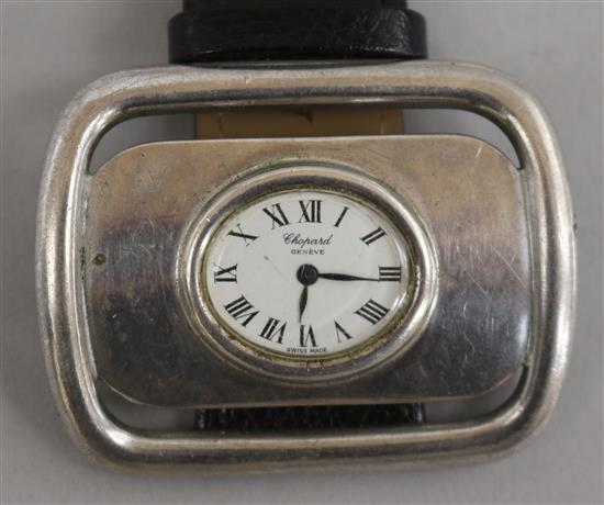A silver Chopard Geneve manual wind buckle wrist watch.